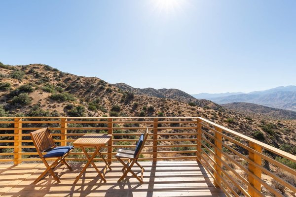 A table and chairs encourage alfresco dining on the deck.