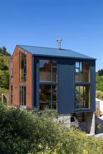 The majority of the house is clad in inky blue metal—a durable, low-maintenance material.