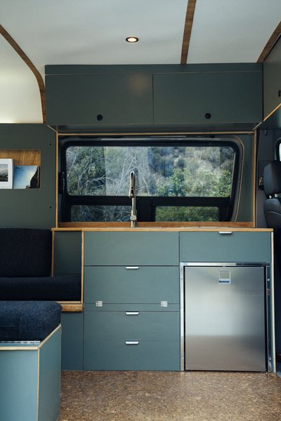 Texino’s cabinetry is sleek, hardy, and functional. In this Sprinter, a kitchenette with installed bench seating makes the saying 