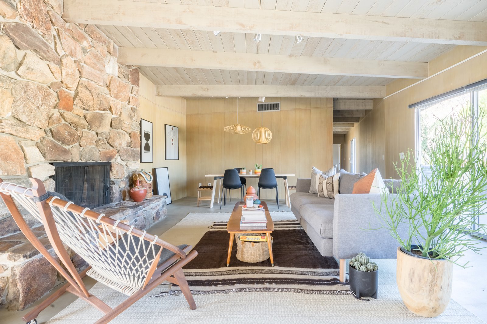 The main hangout space, the living room, is full of fun finds including a Total Design Company rug, local foliage, an HD Buttercup hoop chair and pillows and rugs from The Garage Collective.