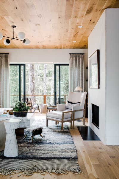 White walls allow for the natural light to really illuminate the space while soft colors prevent the space from looking one-dimensional. The living room features a Minimalist Nordic hearth by Gault Designs