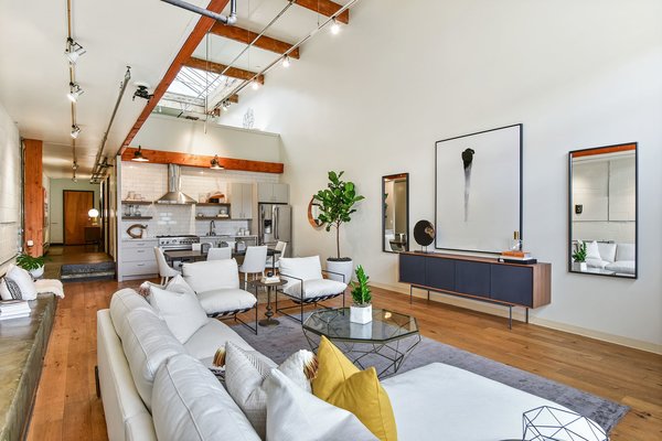 Wide-planed hardwoods line the floor throughout, complementing the various exposed beams.
