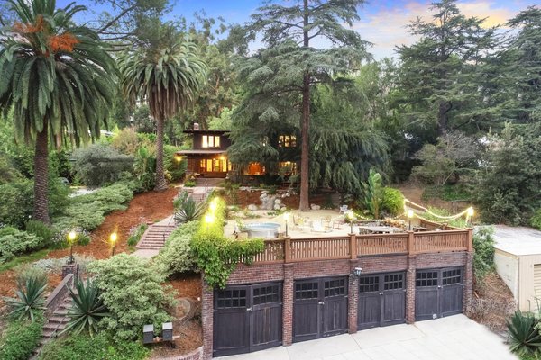 Sited at the rear of a .30-acre lot, both the 1908 guest house and 1905 main residence are surrounded by dense greenery. A four-car garage is tucked into the hillside.