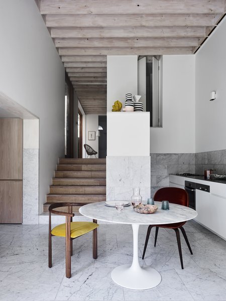 The ground floor steps down to the kitchen and sunken lounge at the rear, and an exposed timber ceiling adds texture and rhythm to the interior. 