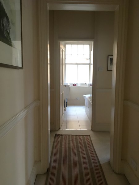 Before: Prior to the remodel, the front door opened into a hallway that segued directly into the only bathroom.