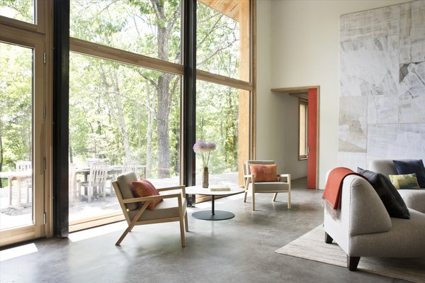 An abundance of south-facing windows connect the double-height living room to the outdoors. 