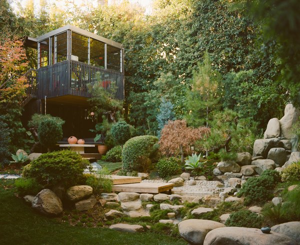 A tea house in the corner of the yard looks out on a small waterfall and pond.