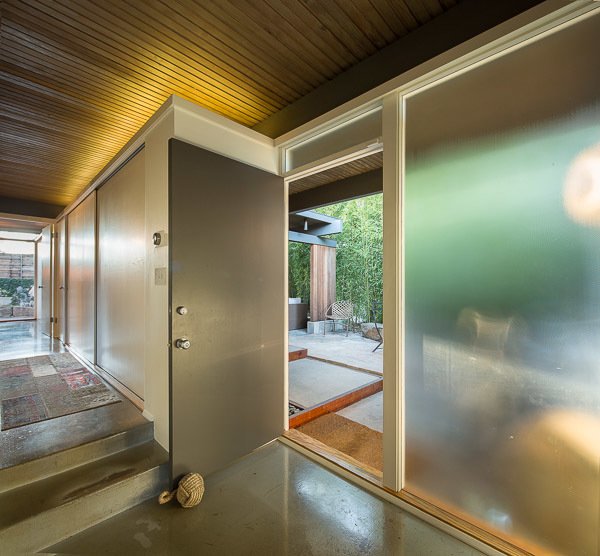 Upon entry, a long, open hallway leads into the main living spaces. 