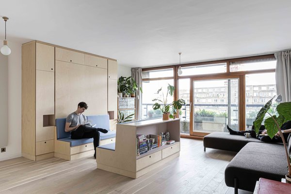With a budget of £10,400 (approximately $13,000), Intervention Architecture transformed a tiny apartment into a minimalist studio. The firm worked with a cabinetmaker to design a custom unit and centerpiece for the space.