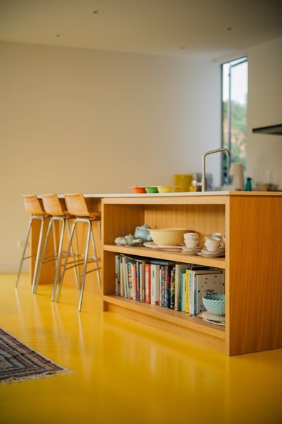 The strand board floor is coated with a super-durable multilayer paint system. Its bright yellow hue ties together the new communal spaces, and it gave rise to the project’s name—The Yolk House.