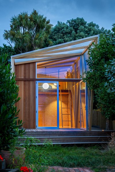 The backyard studio that architect Gerald Parsonson designed to expand a young family’s living space features a wraparound deck that connects the hideaway to the garden.
