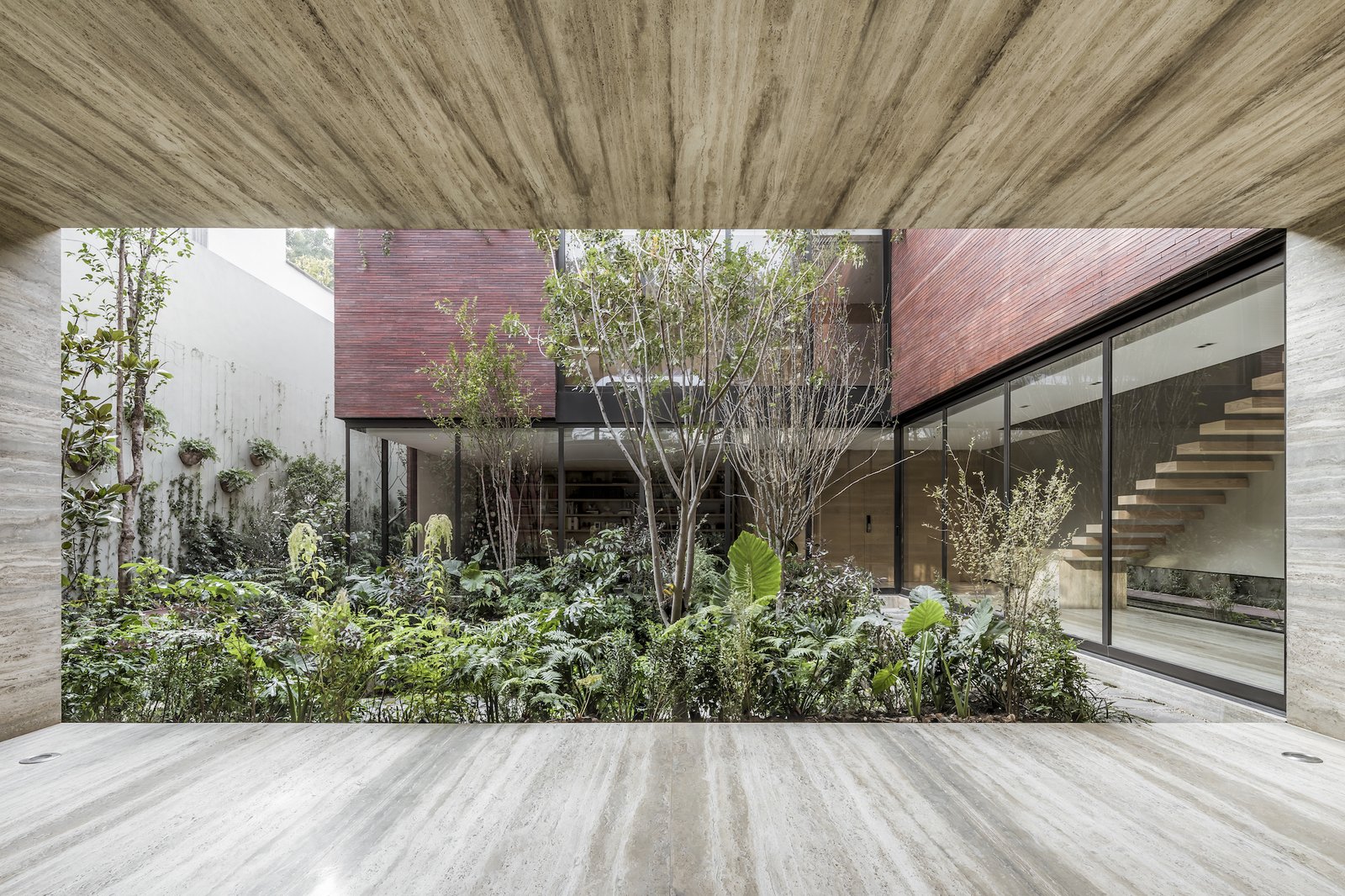 The landscaping was created in collaboration with landscape architecture studio Entorno. "They are extremely talented and have a deep knowledge and understanding of the right composition and best expression of the plants inside a space," says designer Hector Esrawe. 