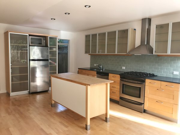 The original kitchen had been renovated in the 1990s, with laminate flooring and frosted fronts. 