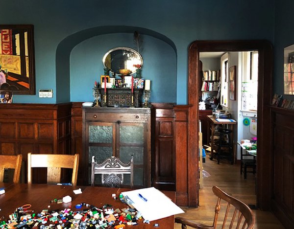 Before: The dining room had an existing niche with original wood wainscoting. The door to the right was the only connection between the kitchen and dining room.