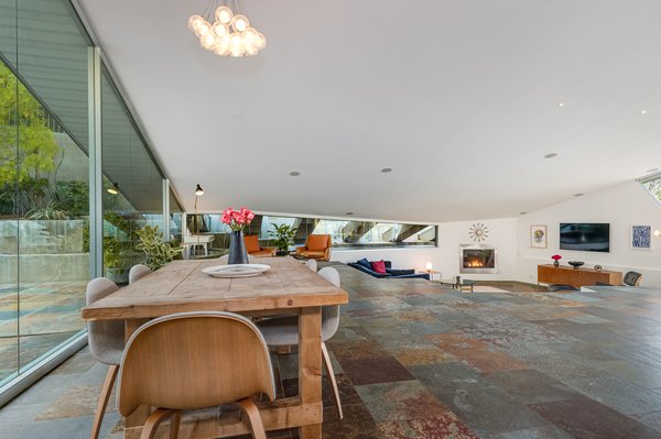 The interiors are bright and airy, with floor-to-ceiling glass and an open-concept layout.
