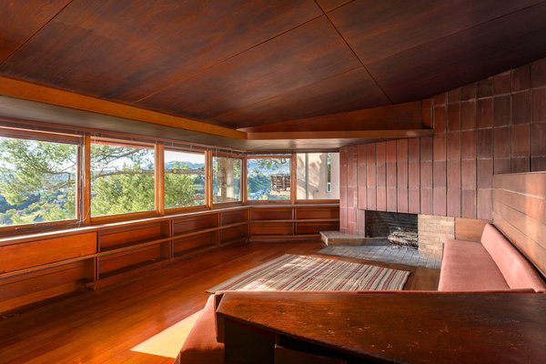 The home helped to establish Lautner’s name independent of his mentor, although Frank Lloyd Wright’s influence is evident throughout. Ribbon windows overlook treetops in the wood-clad living room, which also features a clay tile fireplace and an abundance of built-ins.