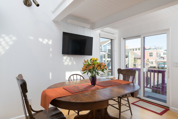 Sliding glass doors in the dining area offer direct outdoor access while framing harbor views.
