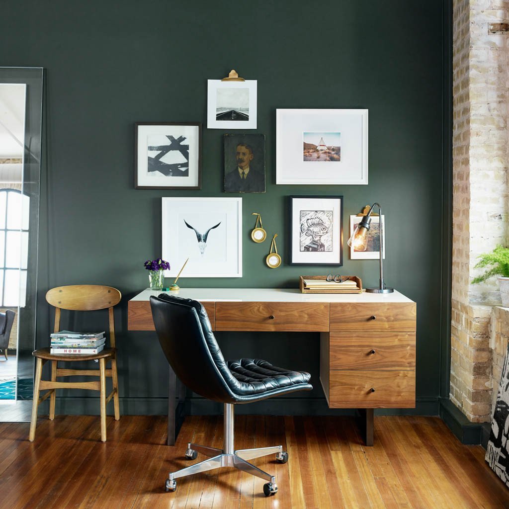 office with wooden desk and green accent wall