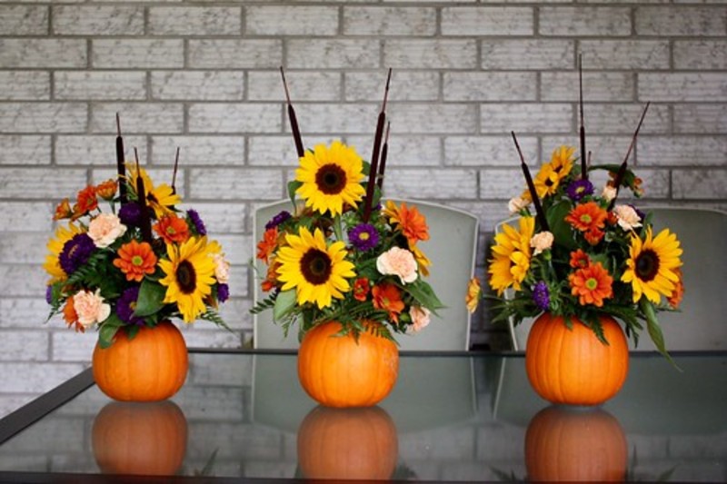 three fall flower arrangements using pumpkins as base
