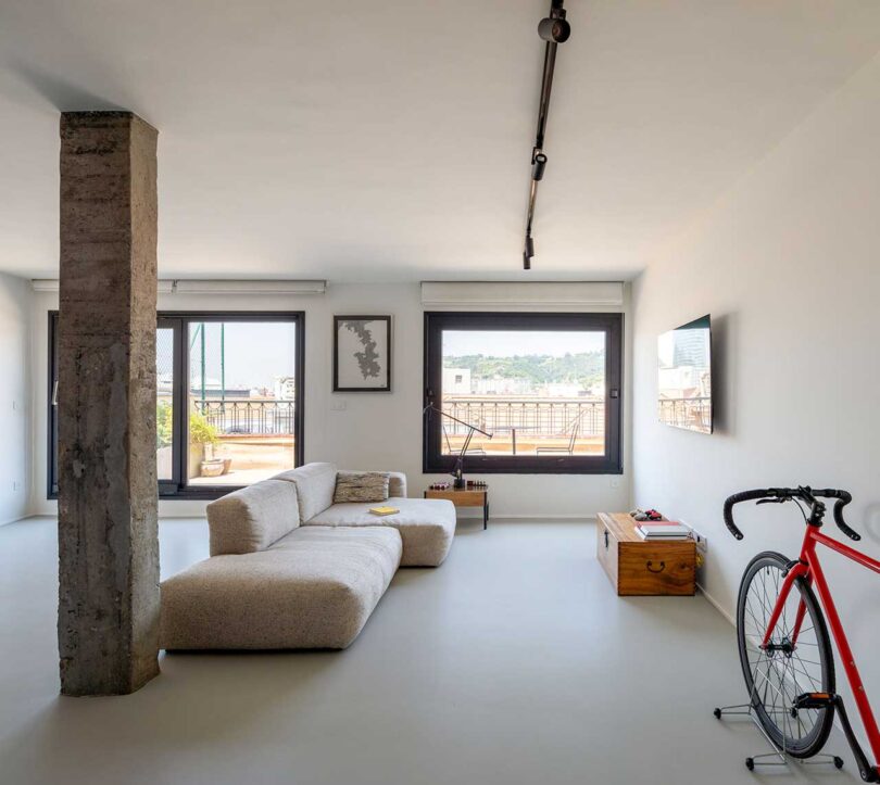 interior view of modern minimalist industrial living room with beige modular sofa