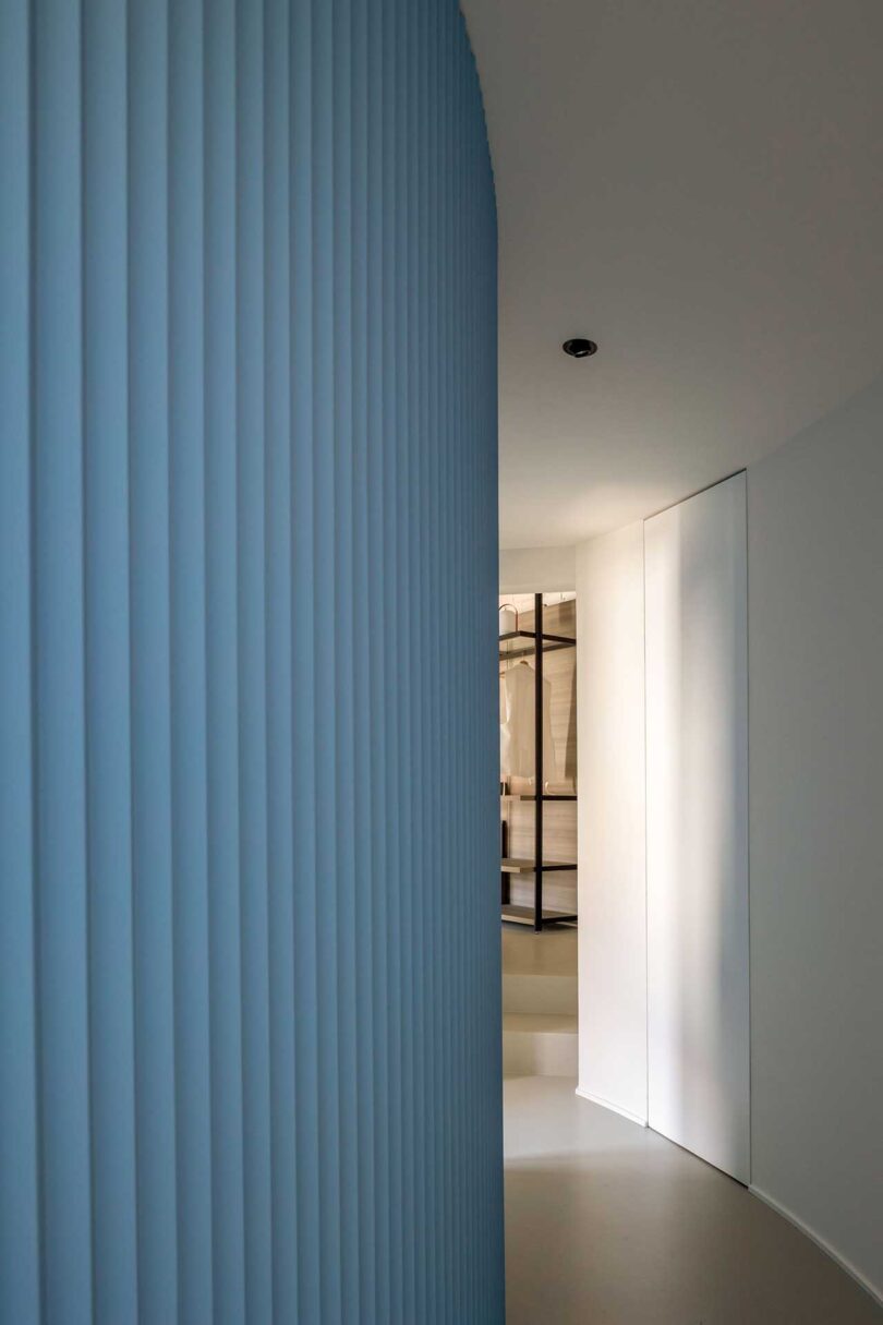 curved hallway with blue fluted wall