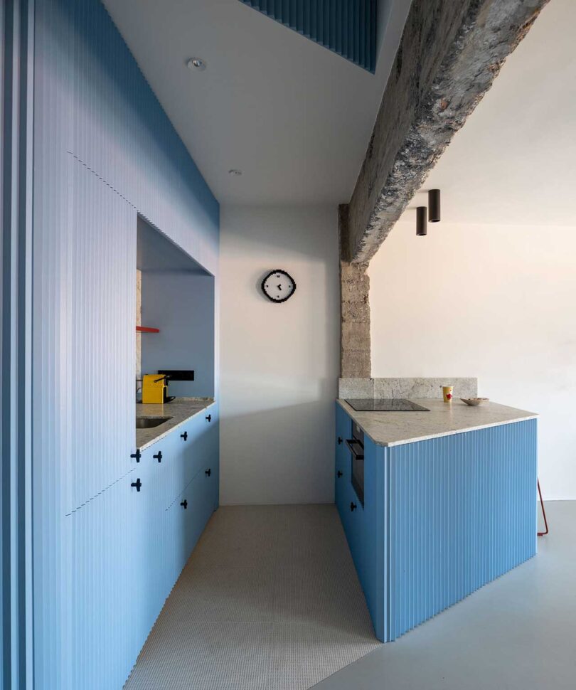 side view of modern light blue kitchen with concrete details