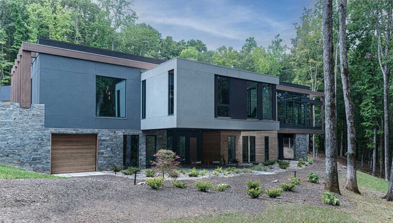 angled exterior view of modern grey house with cantilevered rooms