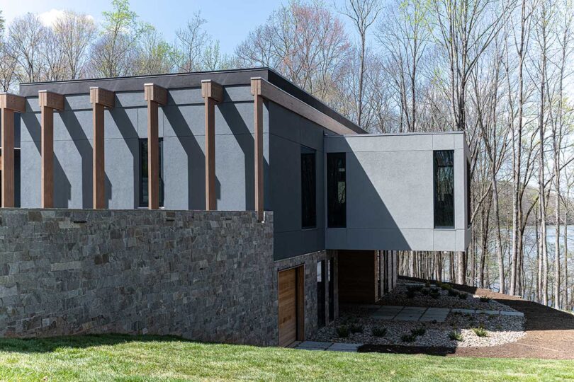 angled exterior view of modern grey house with cantilevered rooms