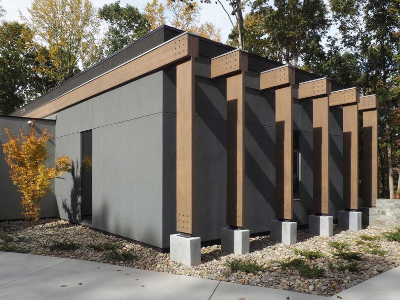 angled exterior view of modern grey house with cantilevered rooms