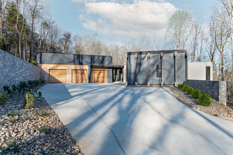 exterior front view of large modern grey and wood house