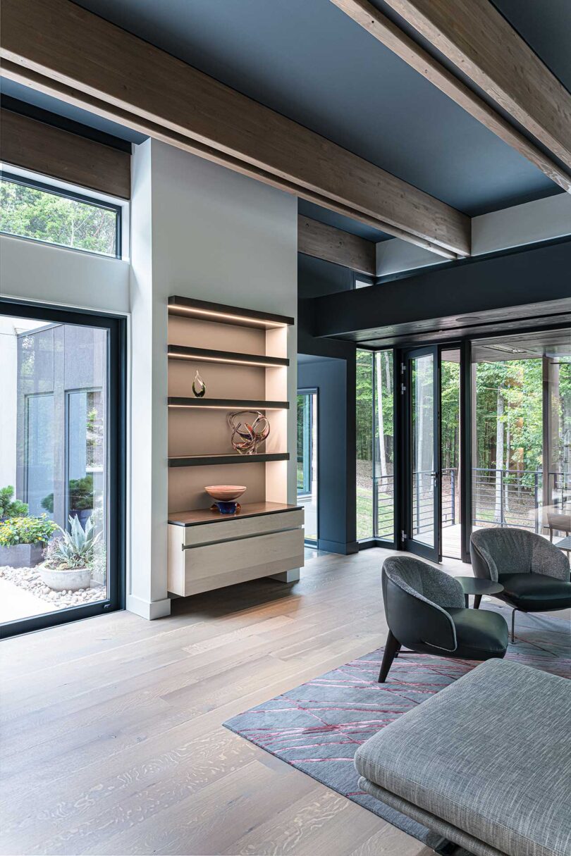 angled interior view of modern living space with high ceilings and light wood floors