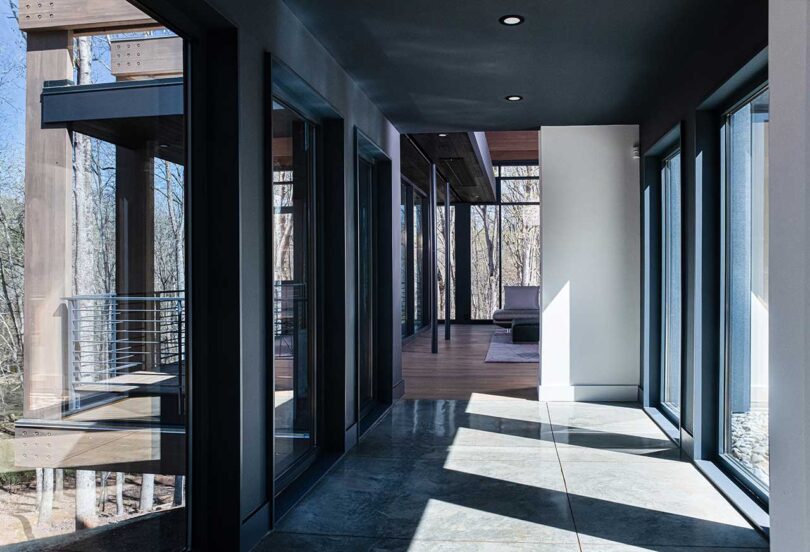 interior view in modern house down hallway flanked with windows