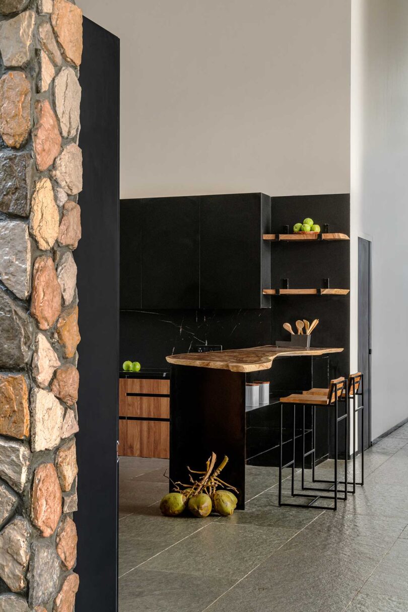 partial view into modern kitchen made of wood and black cabinets