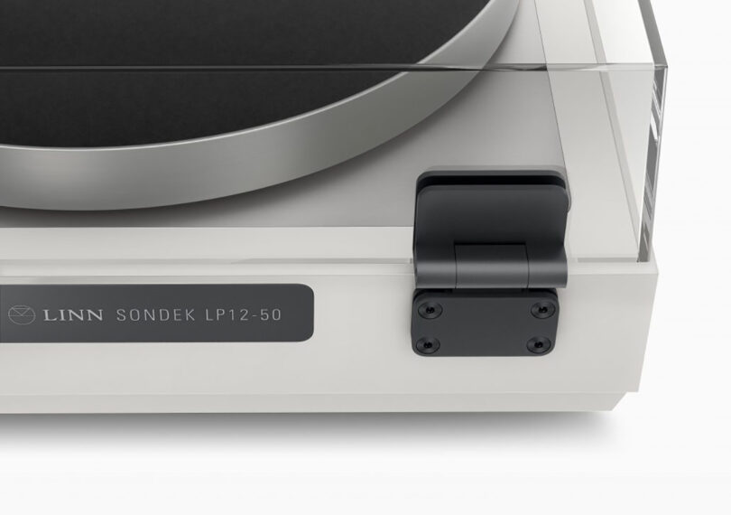 Back right corner of the Sondek LP12-50 turntable showing its new metal hinge design.