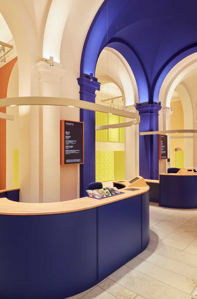 angled foyer view in modern museum with blue kiosk