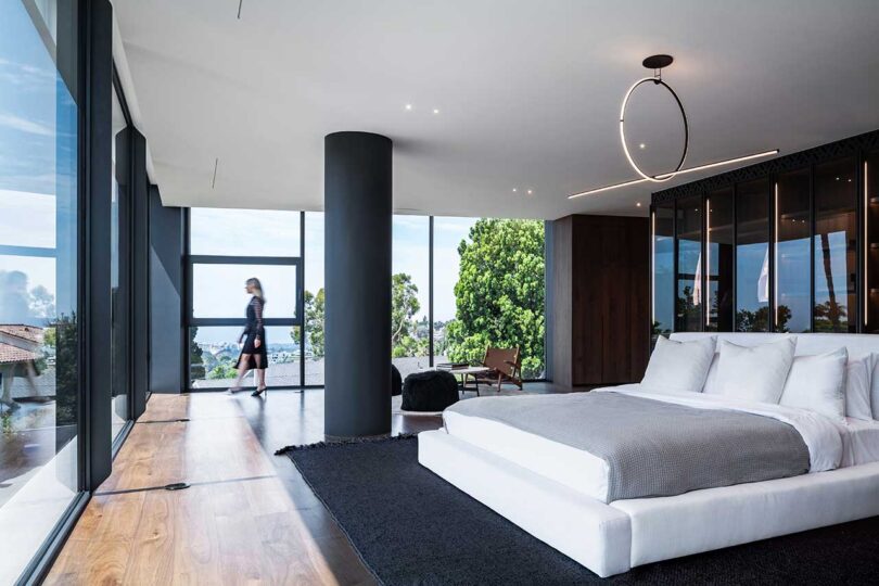 angled view of large modern bedroom with black accents