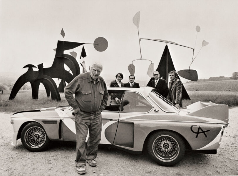 Alexander Calder standing next to the first BMW Art Car