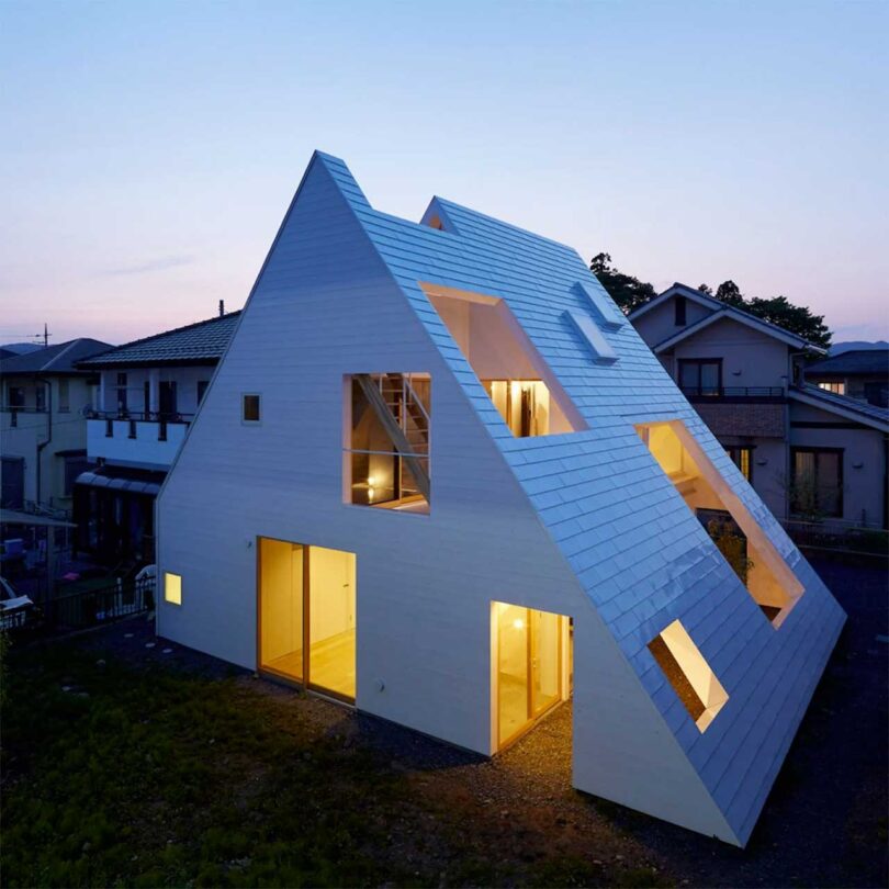angled elevated exterior view of modern all-white a-frame house in Japan
