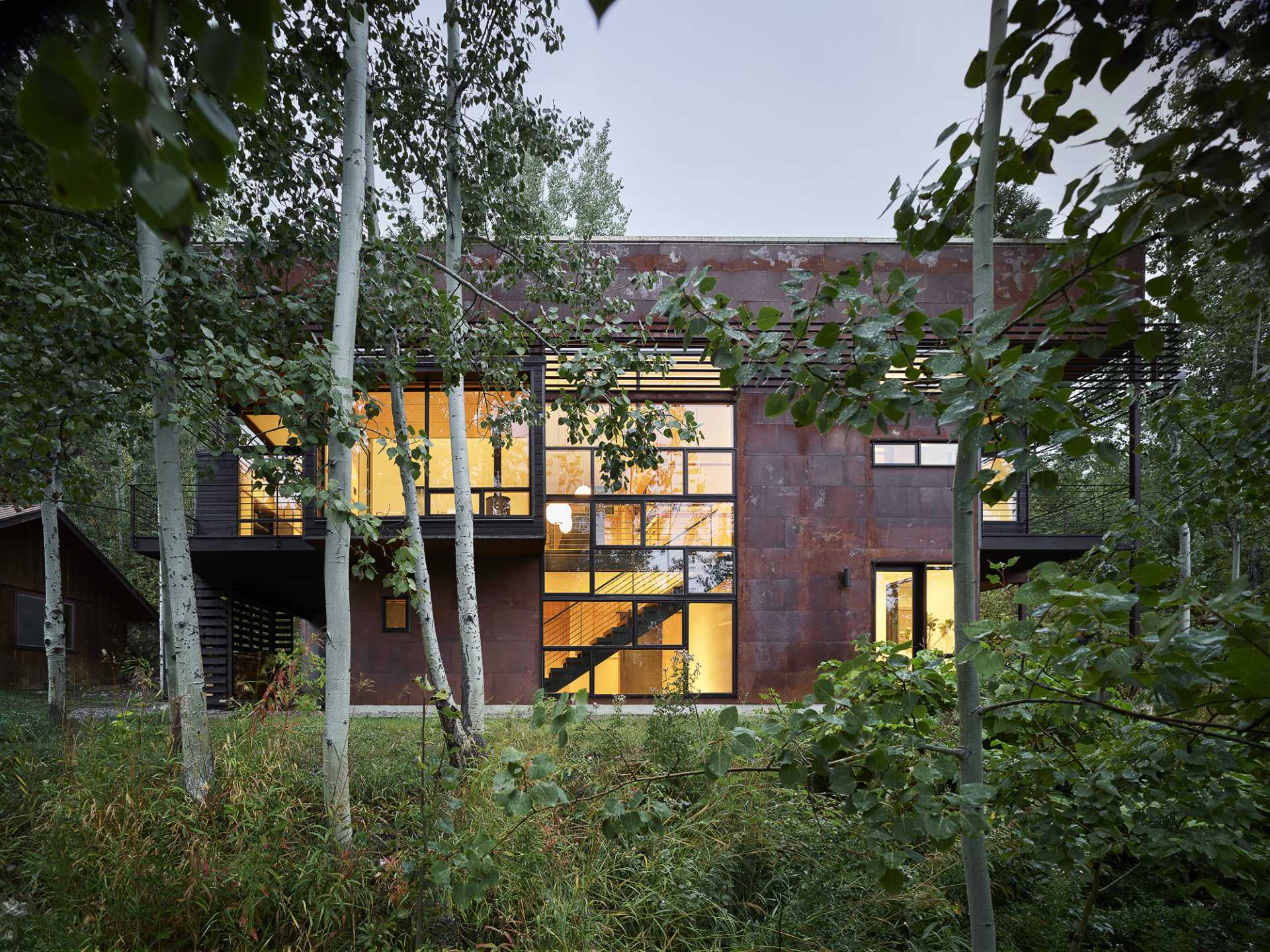 This modern two-storey home incorporates slow-weathering materials such as oxidized steel and cedar, allowing the home to change appearance over time.