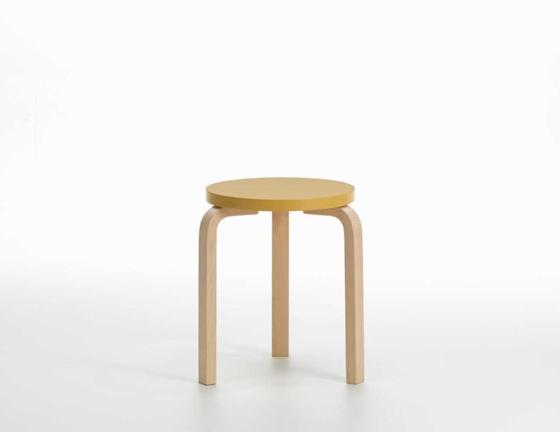 detail of three-legged stool with yellow seat
