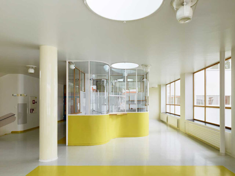 neon yellow and white reception area behind glass