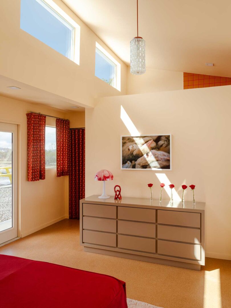 large high ceiling bedroom with modern furnishings in cream and rusty red