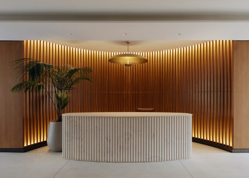 An oval reception desk made with fluted stone