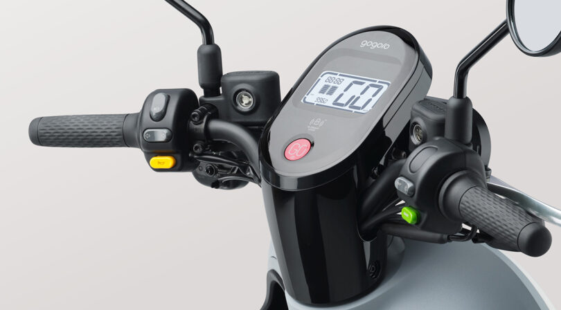 Detail of Muji Gogoro Smartscooter's handlebar and digital display speedometer.