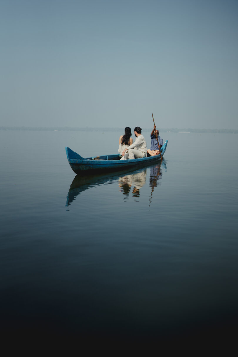 two people float in a canoe on smooth water