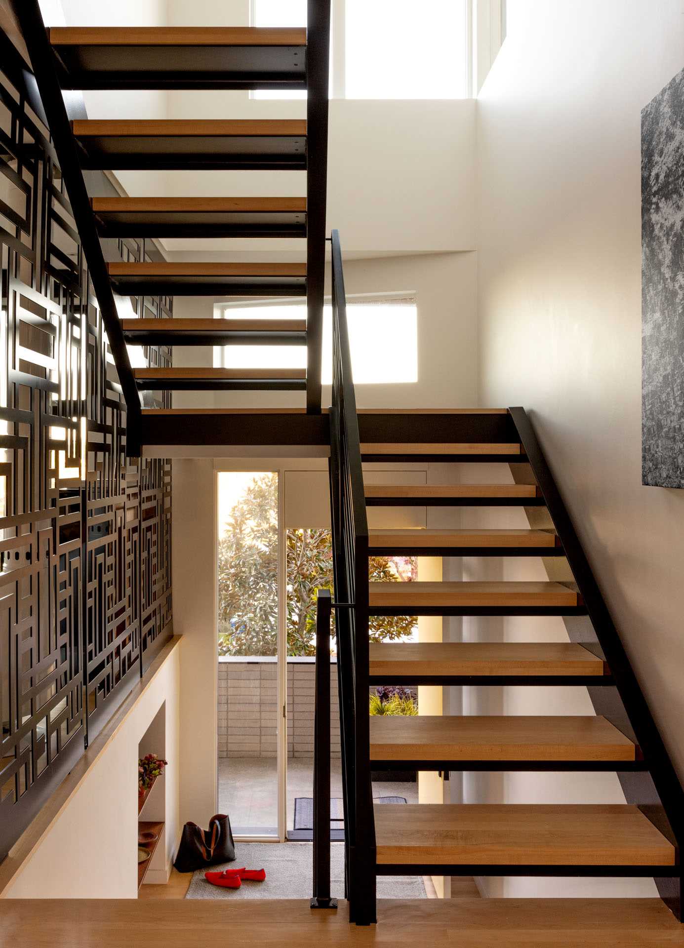Fall protection was integrated into the design of these wood and steel stairs through a patterned screen.