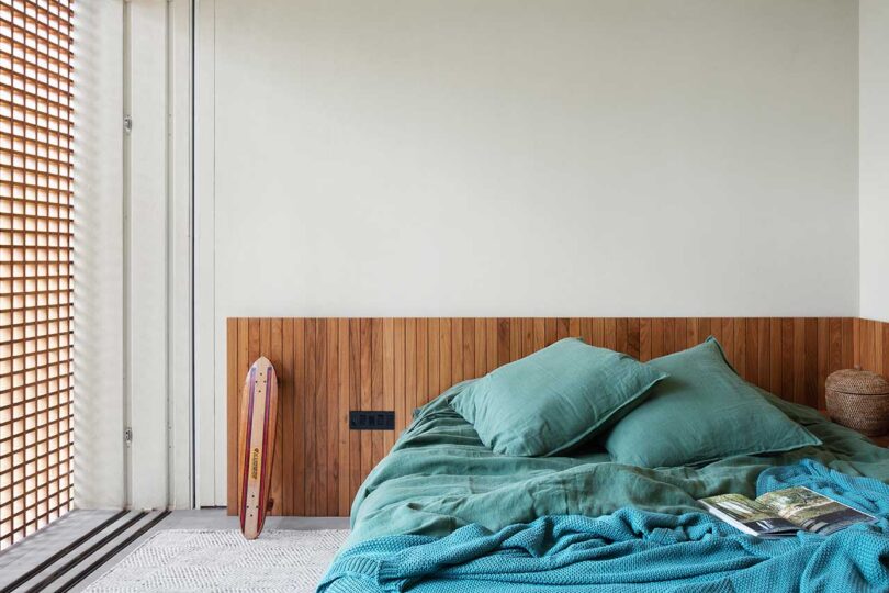 partial view of modern bedroom with teal bedding