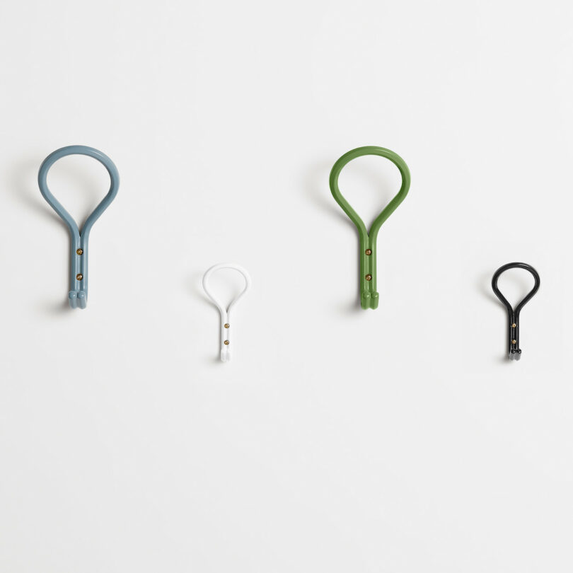 four wall hooks on a grey wall