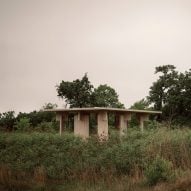 A timber pavilion located in a marsh area