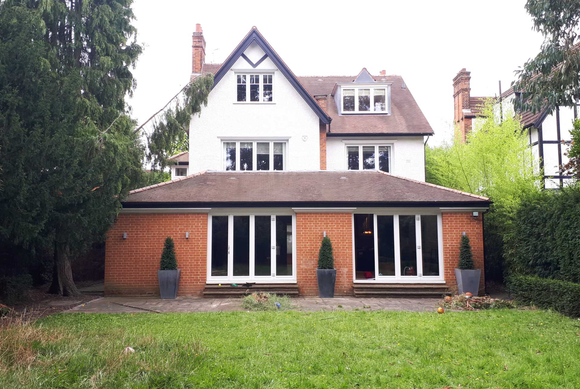 An updated brick extension for an Edwardian home includes a sitting area and dining area for eight people.